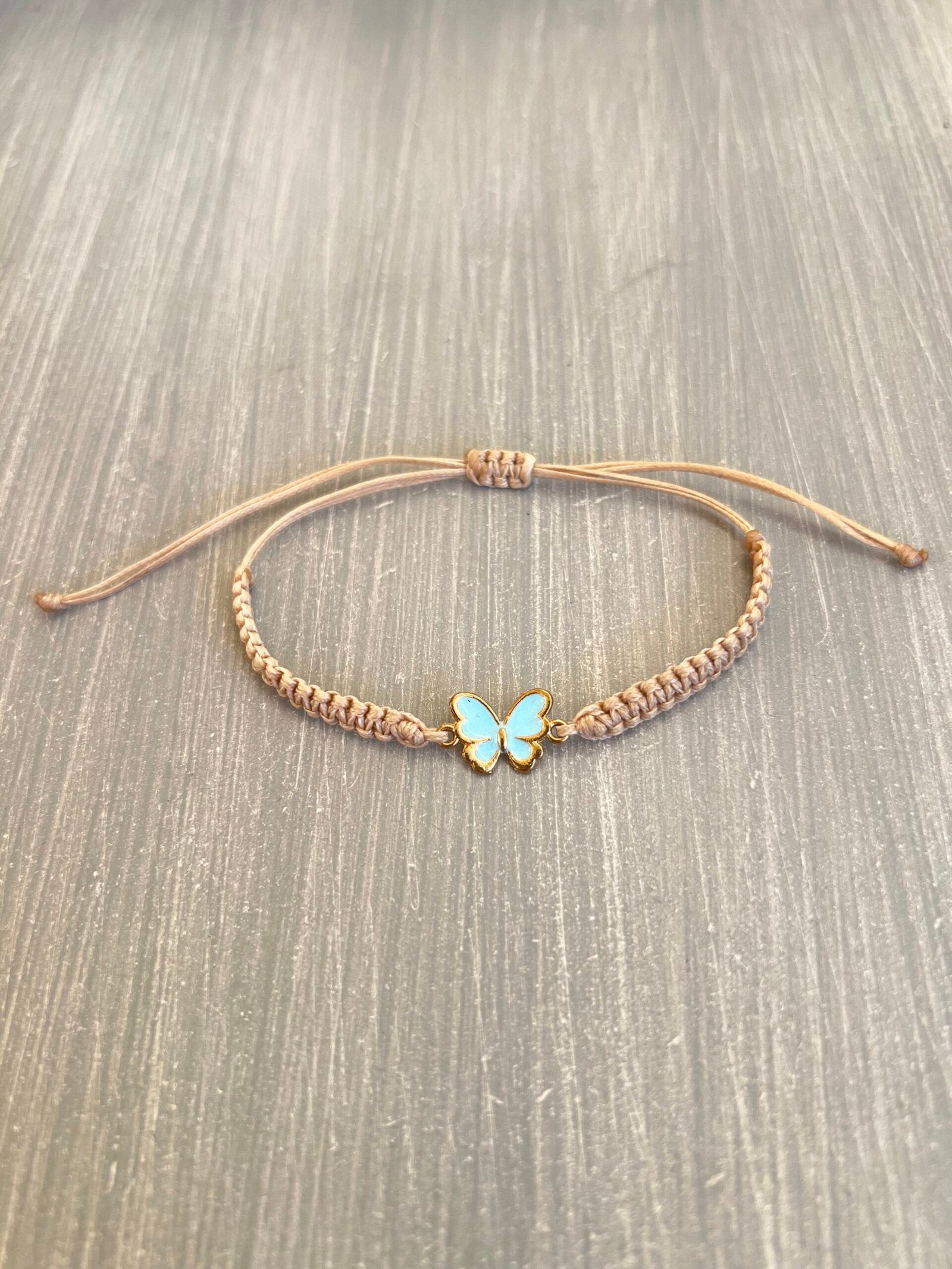BRA85W-scaled-1.jpeg Βραχιόλι μακραμέ γαλάζια πεταλούδα με μπεζ κορδόνι - Image 1